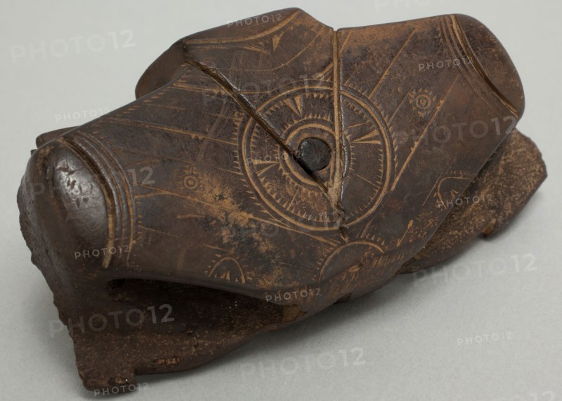 Okvik, Native American, Winged Object Fragment, c. 300, walrus ivory stained black by mineral (graphite) seepage, engraved surfaces, wooden inlays, 1 3/4 x 3 1/2 x 1 in. (4.4 x 8.9 x 2.5 cm)