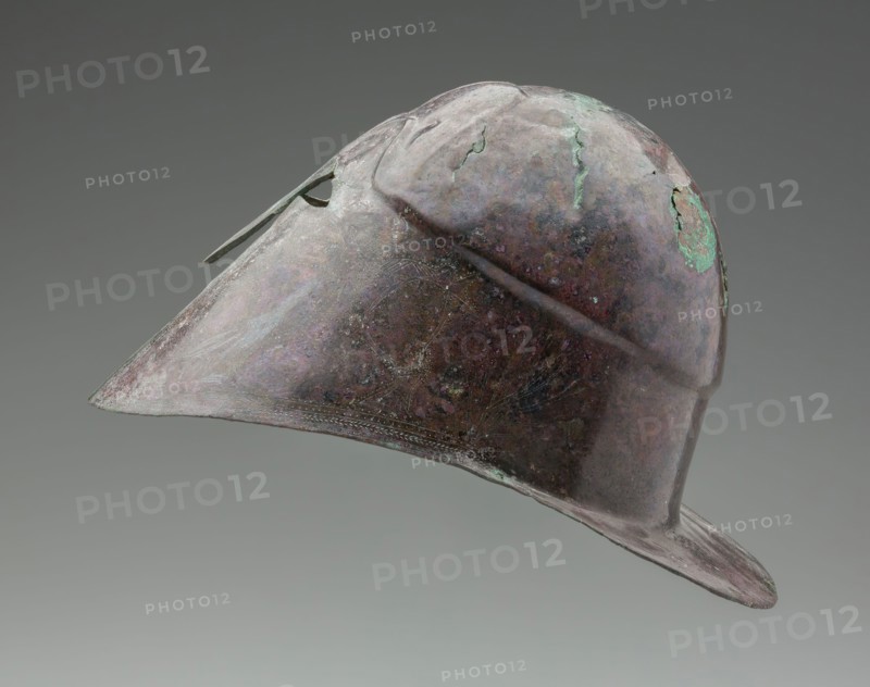 Greek, South Italian Helmet with Decorated Cheekpieces, 4th Century BC, bronze, 7 1/2 x 8 1/4 x 11 3/4 in.