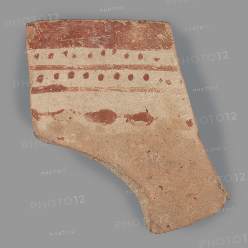 Fragment of a bowl, unknown Northern Mesopotamian workshop, checkerboards, geometric motifs, painted pottery, bowls, Near Eastern pottery, Eastern Gaulish Scenery. Fragment of a bowl wall with a preserved thin rim. Before firing, the decoration, consisting of geometric motifs, was painted with ferrous clay on both sides of the bowl, over a layer of dried, heavily smoothed glaze. After firing, the painted motifs are red, while the background is cream on the outside and light brown on the inside. The outer decoration is a banded composition composed from top to bottom of a wide horizontal band, below which are alternating rows of single dots and two continuous, thin lines. Below this, a single thin line with superimposed irregular ovals remains. On the inner side, the entire surface is covered with a fine red checkered motif. c. 6500–c. 5500 BC; Halaf culture c. 5200–c. 4500 BC earlier dating, Northern Mesopotamia Iraq, Syria, Turkey. Pottery fragment; height 4.7 cm, width 4.6 cm, depth ...