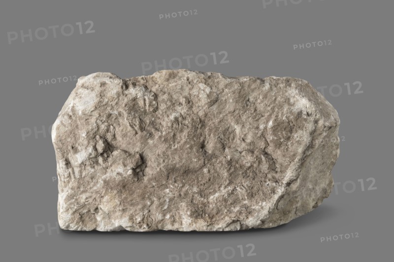Fragment of architectural decoration. Corner section of a fragment of architectural decoration made using the relief technique. The cornice is decorated with bands of ovoid, pearls, cubes, and acanthus leaves. The band decoration is separated by a thin roller from part of the frieze, which depicts a plant tendril with a rosette and a bird. Deep, plastic relief, separated from the background with a drill. 1st–2nd century, Italy. Roman architecture; ovoid ornament; cymatium ornament; plant tendril; pearling ornament; acanthus leaves ornament; friezes; birds decorative motif. Architectural detail / decorative element / architectural element / element of architectural decoration; bas-relief. Height 45 cm, width 30 cm, depth 15 cm maximum, depth 7 cm minimum; weight 15.354 kg., A large irregular rock with a rough, textured surface sits against a flat background; the rock displays shades of beige, tan, brown, gray, and off-white with weathered crevices and uneven edges, and the background ap...