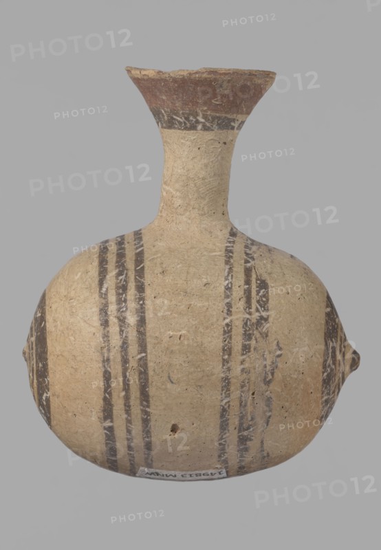 Cypriot gourd jug, Excavated at Nea Paphos Cyprus. Cypriot pottery, Cypriot Bichrome Ware III. Small vessel with a barrel-shaped gourd-shaped body, without a foot, with a spherical bottom. On both shorter sides the center is marked with a small protruding point. A single ring-shaped handle on the longer side, mounted above half the height of the body and at the base of the neck, curving downwards. Quite long neck, strongly flaring, conical spout. Yellow clay with yellow-brownish engobe. Decoration in black-brown and matte red: the spout is decorated externally with a wide matte red band beneath a narrower black band; the belly is decorated on both sides with two groups of three concentric black-and-brown lines of varying widths and spacing, the outer line in the groups on the shorter sides being much wider than the others. Protruding points are marked in black-and-brown. Date: 850–700 BC. Place of origin: Cyprus. Type: vessel., The image shows a rounded ceramic vessel with a narrow nec...