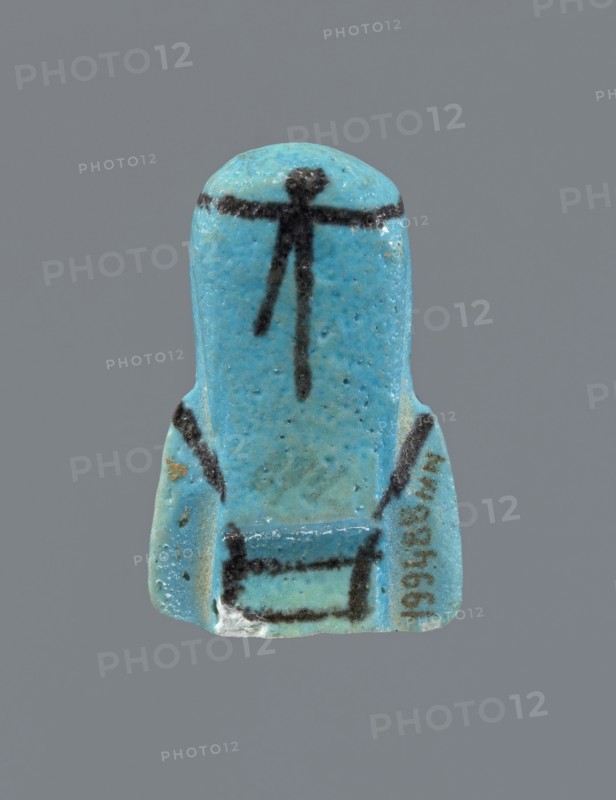 Ushabti, Mummy-shaped figurine, preserved head and fragment of torso. Arms crossed on the chest, hands at the same level, next to each other, holding hoes in each hand. On the back a rectangular basket is slung on strings over both shoulders. On the head is a long, smooth, three-part wig with a headband. Triangular face with proportional details; eyes slightly closed. Headband, tools, and facial details painted. ca. 945–ca. 715 BC; Third Intermediate Period, 22nd–23rd Dynasty, Egypt. Ushabti, height 5.2 cm., A small turquoise-blue figurine-shaped object with a smooth rounded top and flared base, showing a few dark black linear markings on the front including a horizontal line near the top and several vertical and diagonal strokes down the center and sides; the surface shows variations of lighter and darker turquoise with some speckling and tiny pits, a small area of white abrasion at the lower edge, and a faint patch of brown discoloration on one side, all set against a plain gray back...