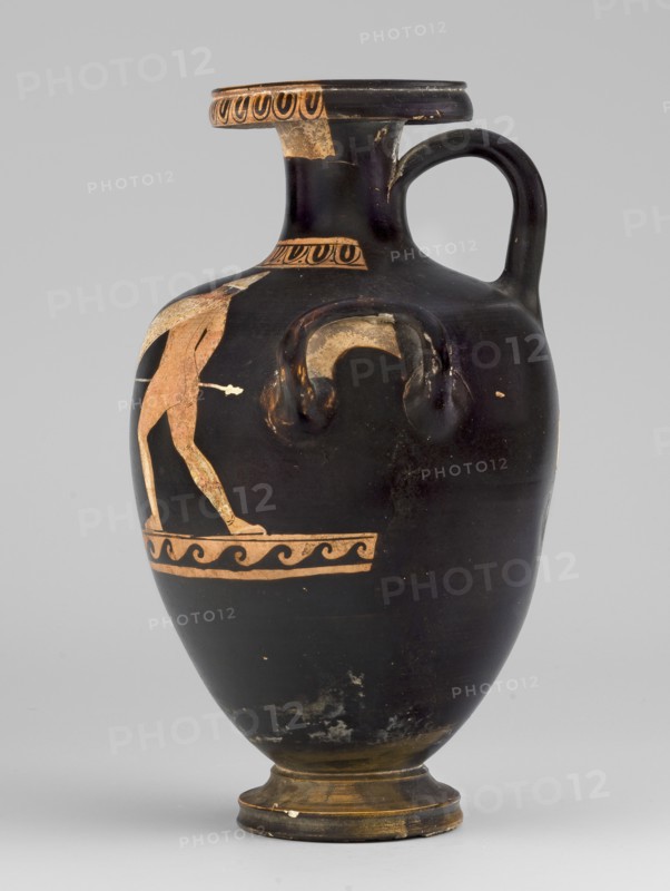 Red-figure hydria with a combat scene of two naked hoplite warriors fighting with long spears. They wear pointed helmets, hold round convex shields in their left hands, and wear greaves; weaponry painted white with yellow retouching. Attributed to the Laghetto-Caivano Group, Duel Painter c. 340–320 / 340–330 BC. Ca. 340–320 BC, Campania. Hydria vessel. Height 22.5 cm; width 15.6 cm; depth 13.3 cm; weight 0.612 kg., A ceramic vessel with a rounded body, narrow neck, and a flared rim with a single handle rising from the shoulder to the rim; the vessel is primarily black with a few worn areas showing a pale orange clay color and some lighter beige patches, and it features a decorative band of pale orange wavy motifs near the lower shoulder and a partial figure in pale orange on one side; the rim has a repeated pale orange circular pattern on its outer face, and the foot and base show worn golden-brown and beige areas.