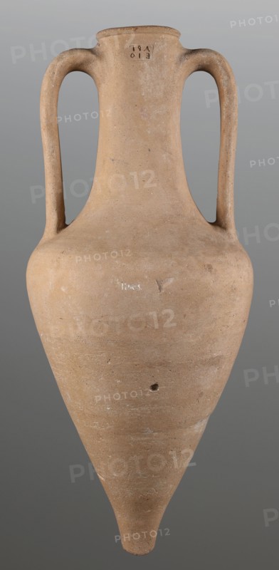 Stamped transport amphora with a Greek inscription Argeio, stamped maker's/official's rectangular stamp on the neck. Transport amphora with pointed bottom, conical belly rounded at sloping shoulders merging into a cylindrical long neck slightly bulging under the annular rim. Ribbon-like handles protrude from the shoulders and run straight up, bending in an arc where they join the neck under the spout. Deeply recessed letters arranged in two rows on the neck stamp; stamp refers to the maker or an official. 400–390 BC. From Heraclea Pontica Bithynia; found at Olbia. Vessel type: transport amphora. Weight 6.326 kg; height 63 cm; diameter 26.5 cm., A tall, narrow ceramic vessel with a pointed base and a rounded shoulder, featuring two symmetrical curved handles rising from the shoulder to the neck; the surface is a muted tan to light brown with subtle variations and small darker speckles, and there are areas of lighter residue and slight abrasion on the body and handles; the background is ...
