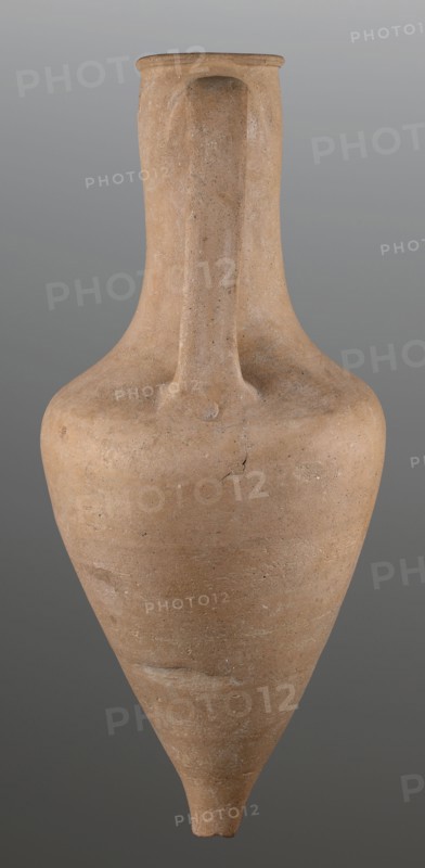 Stamped transport amphora with a Greek inscription Argeio, stamped maker's or official's name. Transport amphora with pointed bottom and conical belly, rounded at sloping shoulders, merging into a cylindrical long neck slightly bulging under the annular rim. Neck stamped with letters arranged in two rows; a rectangular stamp with deeply recessed letters is impressed on the upper part of the neck. Ribbon-like handles protrude from the shoulders, run straight up and bend in an arc where they join the neck under the spout. Eponymous-manufacturer's stamps; stamp impressions indicate maker or official. Greek pottery, transport vessel, ancient pottery. Circa 400–390 BC. From Heraclea Pontica Bithynia; found at Olbia. Vessel type: transport amphora. Weight 6.326 kg; height 63 cm; diameter 26.5 cm., A single tall ceramic vessel with a narrow neck and pointed base fills the frame, showing a smooth, rounded shoulder that tapers down to a conical point; the surface appears slightly rough with sma...