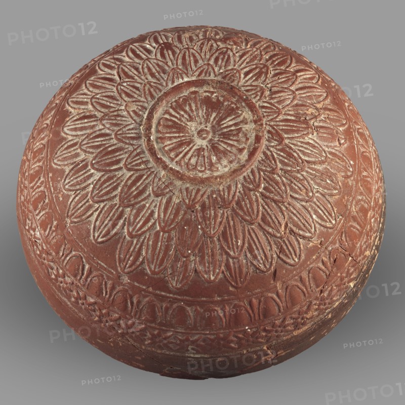 Megarian bowl, Monogramist's Workshop, 2nd half of the 2nd century BC, Ephesus, Ionia; vessel, weight 0.134 kg, A round carved object with a dome shape featuring a central circular motif surrounded by a radiating petal pattern, the carvings showing worn edges and surface abrasions; the piece displays a reddish-brown base color with lighter beige highlights where the carved lines and wear reveal a paler tone, set against a neutral gray background.