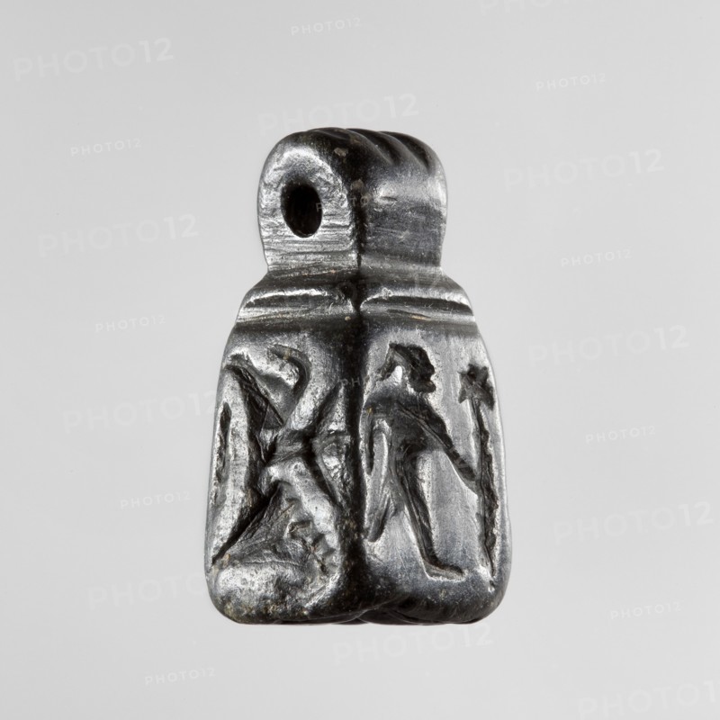 Stamp seal with figural representations. Glyptic stamp seal in the form of a truncated pyramid on a square base, terminated with a round handle. The four side walls and the base are decorated with engraved, stylized figurative representations: two opposite sides depict a rider on a horse; one of the other sides depicts a striding figure holding a staff topped with a star; the opposite wall depicts an animal being attacked by a bird of prey. A winged animal is engraved on the seal's base. Iron Age, 9th–6th century BC; Northwestern Syria Near East. Materials/technique: seal glyptics. Dimensions: height 2.8 cm, width 1.3 cm, depth 1.4 cm; impression carrier dimensions: length 8.5 cm, width 4.4 cm., A small dark gray polished object with a rounded top that has a single circular hole, narrowing slightly toward the top and widening at the base, showing a carved low-relief scene on its front face of two stylized humanlike figures facing each other with elongated limbs and angular poses; the s...