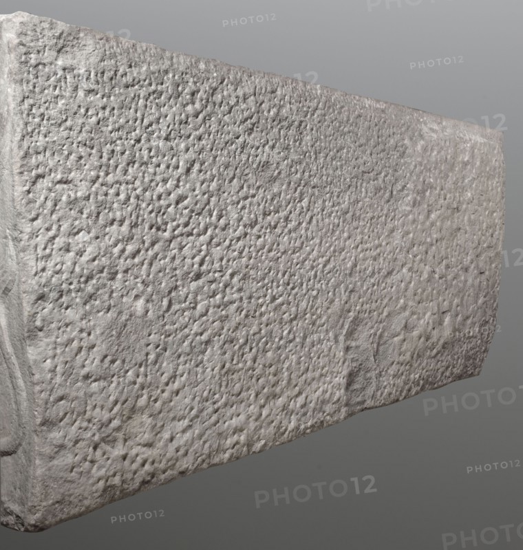 Sarcophagus with a depiction of a married couple and a shepherd, unknown Roman workshop. A large Roman sarcophagus with strigilla S-shaped grooves on the front forming a central medallion, decorated with a standing, thoughtful shepherd leaning on a shepherd's staff pedum. On the sides of the front are figures presumed to be the deceased, standing against draped fabrics parapetasmata: on the left, a woman in a tunic and long cloak palla holding a scroll volumen in her left hand; on the right, a man in a tunic and toga with a contabulatio specially wrapped hem holding a scroll in his left hand and wearing mullei leather military boots. Both front figures have incompletely finished heads. The side walls show reliefs of a seated griffin with a lion's head; the left wall near its lower left corner has an opening into the interior. The lower left corner of the right wall is missing and the rear wall is rather carelessly worked. The piece shows abrasions and damage, particularly to the corner...