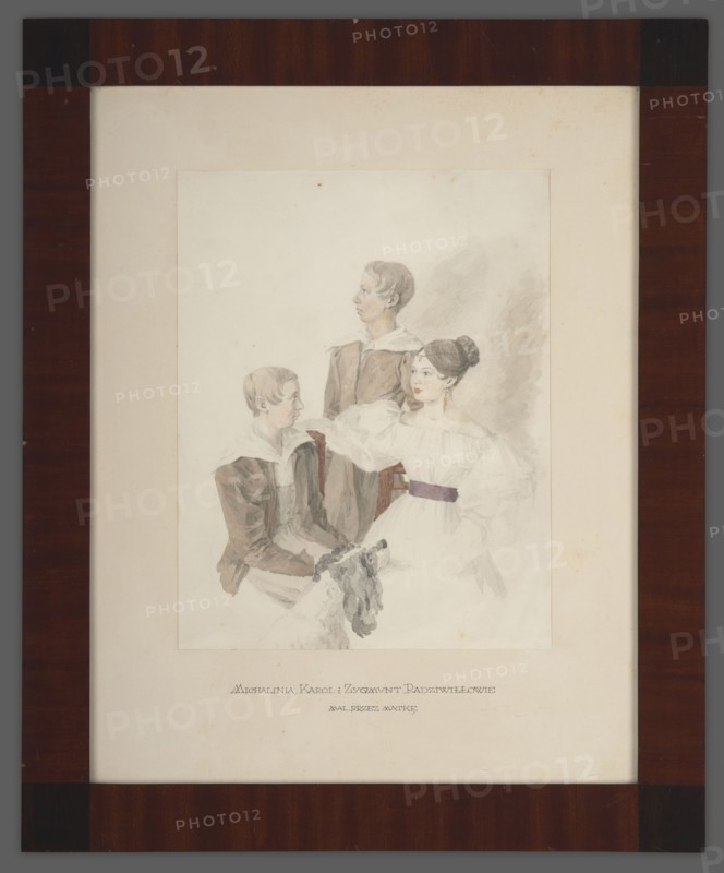 Portrait of Michalina 1816–1883, Karol 1821–1886 and Zygmunt Radziwill 1822–1892; Radziwill née Stecka, Aleksandra 1796–1864 author, ca. 1838, Poland; portrait; height 43.5 cm, width 34.2 cm., A framed watercolor portrait shows a group of three young people positioned closely together on a pale background; a young woman sits in the foreground wearing a white dress with puffy sleeves and a dark belt, her dark hair styled in a bun and a long earring visible, while two boys in brown coats with white collars sit and stand beside her, one seated looking toward her and one standing behind looking to the side. The painting is mounted on a creamy off-white mat and enclosed in a dark brown wooden frame with a warm reddish tint and subtle wood grain. The visible colors include white, brown, cream, pale gray, muted purple, and touches of gold.