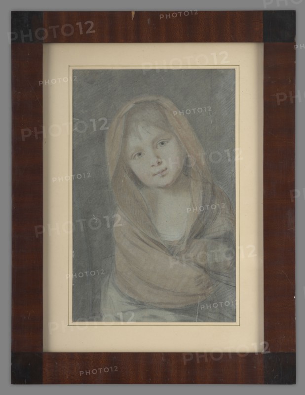 Krystyna Radziwillówna 1776–1796, unknown artist, circle of patronage of Helena Radziwill. Bust of a little girl facing forward, head tilted to the left, wrapped in a shawl, ca. 1783. Portrait, height 36.2 cm, width 26.5 cm., A framed portrait of a young person wearing a hooded shawl, shown from the torso up, with a tilted head and a neutral expression; the portrait is rendered in soft, muted tones with visible shading and pencil or pastel-like texture, featuring a grayish background and skin tones that appear pale with subtle pinkish highlights; the shawl is rendered in warm beige and light brown hues, and the clothing beneath shows muted blue-gray tones; the frame surrounding the portrait is a dark reddish-brown wood with darker corner accents and a cream-colored mat that has a narrow inner border.