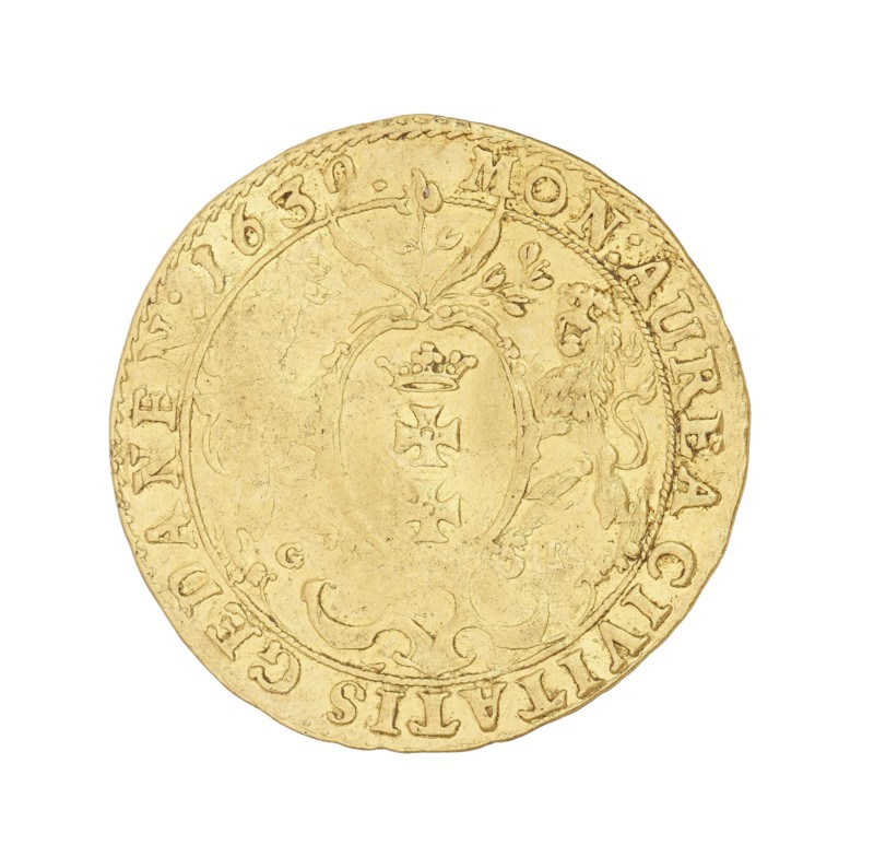 Gdansk ducat; Rogge, Gerhard fl. 1639–1657, co-creator; Wladyslaw IV Vasa King of Poland; 1632–1648, author; Poland; Gdansk; coin., A circular metallic object with a worn surface, shown against a white background, featuring a raised decorative border and an inner oval cartouche flanked by a stylized lion figure and ornate floral-like scrollwork; the surface shows irregular edges and textured wear, with engraved decorative motifs including a small crown and cross-like shapes within the central oval. The visible colors are gold and pale yellow.