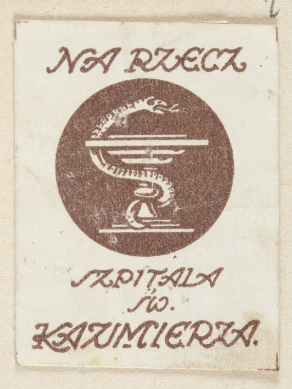 Depicting the chalice of Hygieia and the inscription: FOR THE SAINTS OF ST. CASIMIER'S HOSPITAL; unknown creator; charity; Poland; World War 1914–1918; 20th century; charity stamps; health service; Radom Masovian Voivodeship; 1917; Radom; print; ephemera., A rectangular off-white card with a faded brown circular emblem in the center depicting a coiled snake-like form entwined around a horizontal bar and a small pedestal-like shape, surrounded by decorative brown script above and below the circle; the card shows light stains and aged discoloration with tones of beige, cream, brown, and small darker specks.