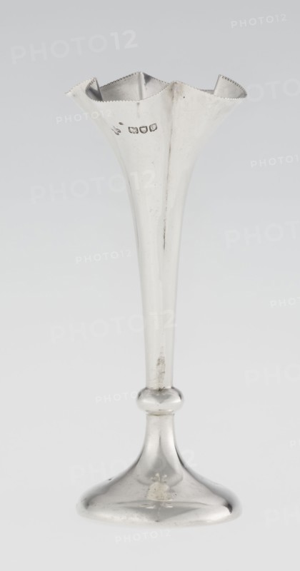 Chalice-shaped vase, maker: Woodward, Horace & Co Ltd Birmingham, London; fl. ca 1851–1919; corporate slogans / goldsmith's firm; purchase provenance; scrap - purchase. Flowers vessel, pearling ornament. Vase supported on a circular foot transitioning into a short stem terminating in a ring, with a goblet in the form of a slender flower calyx; tall, conical, quarter-part at the top edged with pearling. Date: 1899/1900. Place: Great Britain — England, London. Vessel. Height 12.5 cm; width 5.5 cm; depth 5.5 cm; weight 38 g., A tall slender metal vessel with a flared, scalloped rim and a narrow elongated stem widening into a rounded knop and a domed base; the surface is reflective and shows areas of slight tarnish and small scratches; visible colors include silver tones on the metal and subtle gray variations in the background.