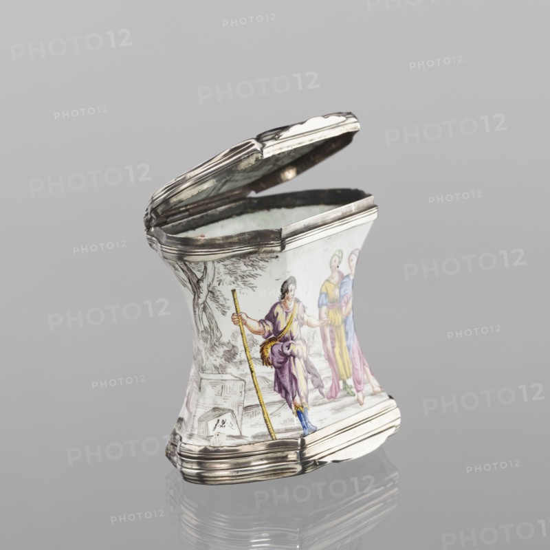 Double snuffbox, enameller LZ France?, fl. ca. 1700. Double-sided snuffbox, tall, narrowed halfway up; slightly bulging lids framed by silver with profiled fittings. White-enameled, decorated with colourful scenes from the story of Samson against grissaille-painted landscape backgrounds. Sides: two scenes—Samson going to the Philistine city of Timna shown the way by three women, and Samson fighting a lion. Lids: Samson carrying the city gate to the top of the mountain opposite Hebron, and Samson taking honey from the lion's mouth. Reverses of the lids: two landscapes with architecture painted in grissaille and colourful flowers painted in the bottoms. Enamelling; early 18th century, France . Smoking accessory. Height 7 cm, width 7.7 cm, depth 4.7 cm., A small curved container with a hinged lid made of silvery metal and white porcelain, decorated with painted figures and a landscape; the porcelain shows a group of three people in flowing garments in purple, yellow, pink, blue, and green...