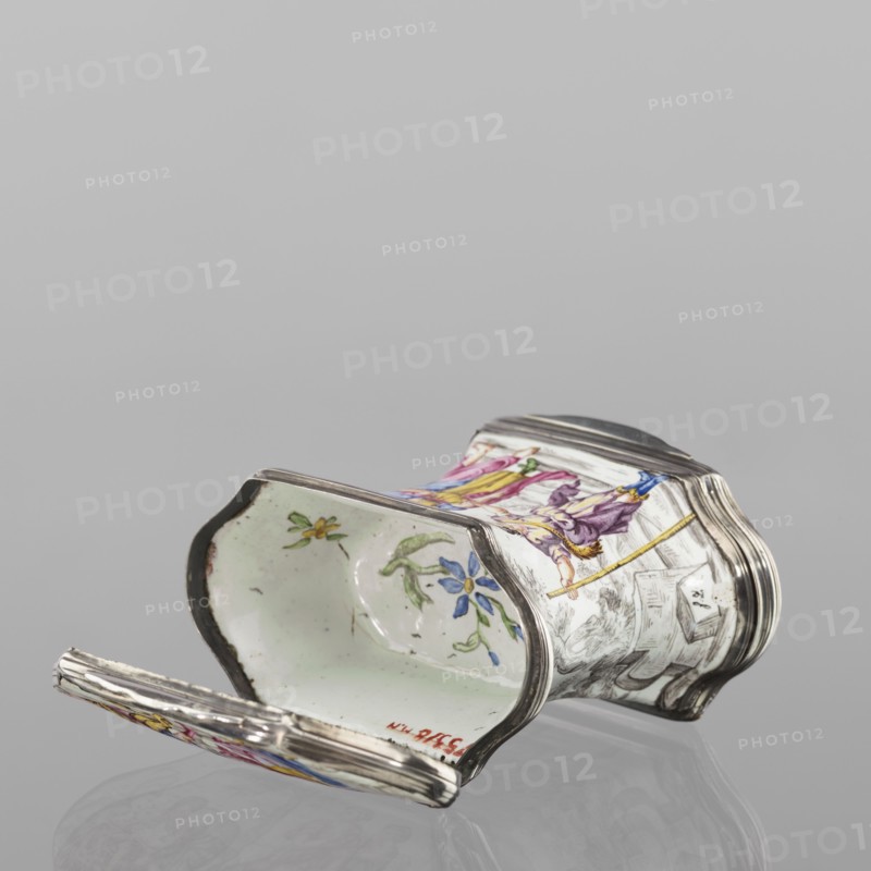 Double snuffbox, enameller LZ France?, fl. ca. 1700. Double-sided snuffbox, tall, narrowed halfway up; slightly bulging lids, framed by silver, profiled fittings, white-enameled, decorated with colourful scenes from the story of Samson depicted against a landscape painted in grisailles. Sides: Samson going to the Philistine city of Timna, shown the way by three women, and Samson fighting a lion. Lids: Samson carrying the door the city gate to the top of the mountain opposite Hebron and Samson taking honey from the lion's mouth. Reverse of the lids: two landscapes with architecture painted in grisailles and colorful flowers painted in the bottoms. Technique: enamelling, painted enamel. Iconography: Samson Bible, Samson fighting a lion, Samson collecting honey from a lion's mouth, flowers, landscape. Early 18th century, France . Function: smoking accessory. Dimensions: height 7 cm; width 7.7 cm; depth 4.7 cm., An ornate small container lies on its side against a neutral gray background, ...