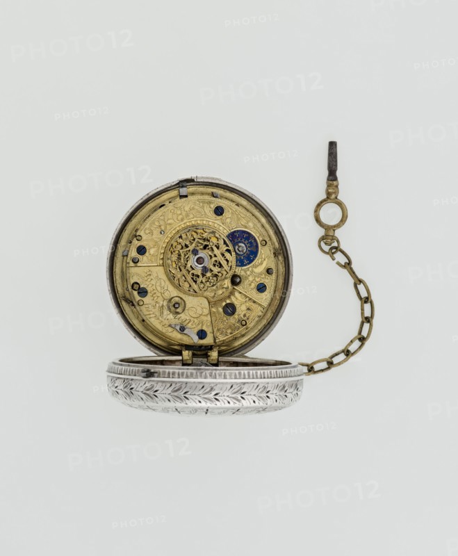 Pocket watch with key by Eardley Norton born 1728, died 1792; fl. 1770–1792. Two silver cases: smooth outer case and inner case with framed glazed lid; mechanism cover engraved with an openwork floral/acanthus twig, with a winding hole and bell. Repeater mechanism. White enameled dial with black Roman hour numerals, minute scale marked with dashes, calendar with Arabic numerals, three steel hands hour and minute openwork weave, third straight for day of month, small seconds subdial with Arabic numerals at bottom. Dial signed EARDLEY NORTON / LONDON. Movement: gilded brass with circular plates connected by pillars, spring-powered drive, spindle escapement; lower plate with openwork crown richly decorated with acanthus tendrils and engraved acanthus volutes; cut-out reserve engraved Eardley / Norton London. Preserved winding key on a chain. Case: Germany, 3rd quarter of the 18th century; maker casemaker active in Germany; movement/case work associated with London. Timepiece. Dimensions: ...