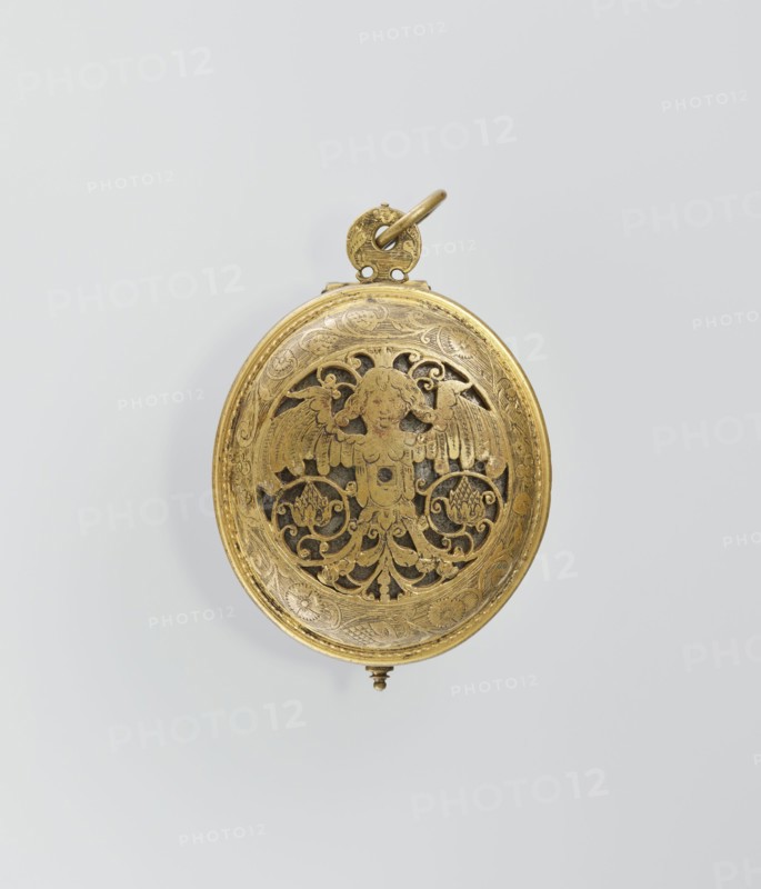 Pectoral watch, maker: I. Stosch fl. 1st half of 17th century. Baroque, 17th century mechanism dated 1st half of 19th century. Oval case with frame and circular glazed cut-out revealing a dial with a silver ring and hour numerals. Frame engraved with a tendril; underside open-work with a winged bust merging into a tendril and surrounding tendril motif. Openwork sides with tendril ornament, floral and grotesque decoration. Mechanism with striking device, signed I. STOSCH. Timepiece; height 5.3 cm, width 3.5 cm. Place of origin: Wroclaw., A circular metal object with a warm gold color hangs against a pale gray background; the front surface is decorated with ornate openwork showing a symmetrical winged figure surrounded by scrolling foliage and floral motifs, all rendered in the same gold tone with darker recessed areas visible through the cutouts; a small round loop and ring at the top, also gold, attach to the piece, and a tiny decorative finial projects from the bottom, while the surro...