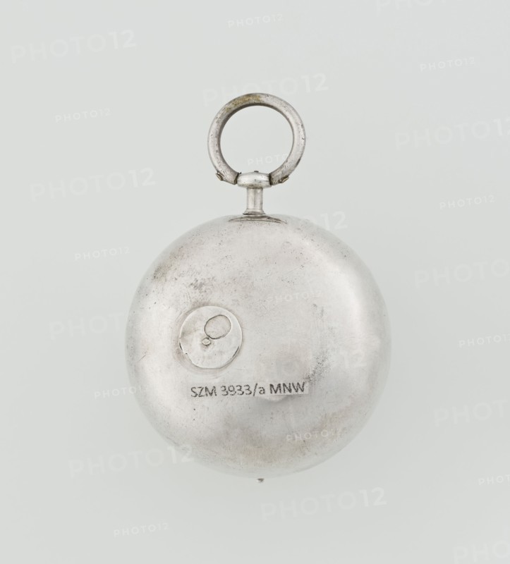 Pocket watch by John Bushman 1692–1720. Silver pocket watch in three cases: outer case covered with leather, rim decorated with studded silver rosettes; middle and inner cases plain. Underside of the inner case engraved with the casemaker's initial H and the number 3081. Transparent lid; silver champlevé dial with Roman numeral hour markers and Arabic minute markers in oval reserves on a matte background; central circular reserve with the watchmaker's signature on two semicircular plates reading BUSHMAN and LONDON; date window at the bottom. Steel hands with an openwork hour hand. Movement with a plate skeleton, spring drive, worm gear, and Gall chain; spindle escapement. Gilded lower plate with an openwork English-style bun in the form of a wreath filled with acanthus tendrils and an openwork grid, connected by a mascaron mask with an openwork bun foot. Hair adjustment is a rotating silver-plated dial with a scale I–VI. Engraved on the plate in italics: Jn Bushman 3081 / LONDON. Circa...