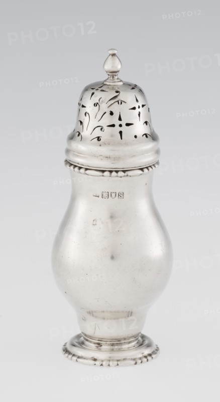 Powdered sugar bowl, pear-shaped on a circular profiled foot, with a domed openwork cover topped with a bowl. Edge of the foot and the top rim decorated with astargal. Openwork; sugar vessel; astargal ornament. Maker: Richard Burbidge 1847–1917, goldsmith. Date: 1913–1914. Materials/technique: likely silver; function: dish. Dimensions: height 15 cm, diameter 5.9 cm, weight 152 g. Place: London, England., A single metallic object with a shiny silver surface shaped like a rounded vase with a domed, perforated lid topped by a small finial; the lid shows decorative cutout patterns and the body has a smooth, curving profile with a beaded rim near the top and a fluted circular base with small raised bead details; visible surface wear and small scratches create subtle darker marks against the silver, and the background is a plain light gray.