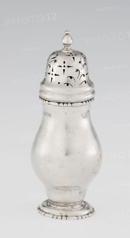 Powdered sugar bowl; pear-shaped powdered sugar bowl on a circular profiled foot, with a domed openwork cover topped with a bowl. Edge of the foot and the top rim decorated with astargal. Openwork; sugar vessel. Maker: Harrod's Stores Ltd London, maker's role: goldsmith Richard Burbidge 1847–1917. Date: 1913–1914. Place: London, England. Dish. Height: 15 cm; diameter: 5.9 cm; weight: 152 g., A single metallic object shaped like a bulbous container with a domed, pierced lid topped by a small finial is shown against a plain light background; the object has a smooth reflective surface with a few small blemishes and scratches, a decorative beaded band near the top and base, and visible cutout patterns on the lid; colors present include silver, gray, and subtle darker gray tones.