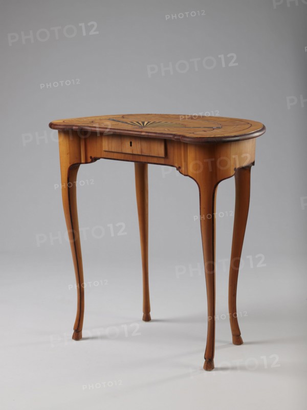 Table, Auxiliary table supported by four slender, slightly curved S-shaped legs framed and bound with a rosewood ribbon; feet in the form of hooves, stained black. Front frame concave with a small central drawer. Tabletop decorated centrally with a fan enclosed by four fields separated by a ribbon of irregular, rounded outline and a narrow crosswise frame. Fan setting inlaid with mother-of-pearl rosettes, bound with tin veining; lower part of the fan features alternating light and dark areas. Tabletop edge veneered with yew solid wood. Mortise lock, single-bolt with brass plate. c. 1730–1750, Saxony, furniture; height 72.5 cm, width 71.5 cm, depth 46.2 cm., A wooden side table with a kidney-shaped top sits on a light background; the table shows a warm honey-brown finish with darker brown edging and inlaid darker wood patterning on the top, and a subtle fan-shaped decorative motif in contrasting tones; the apron has a small recessed central panel and gently curved cutouts, and the table...