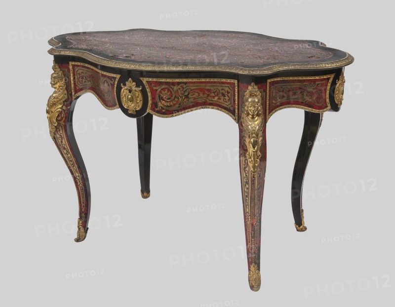 Table, unknown origin, plant decoration, neo-baroque style, plant tendril, female busts, 1870–1880, France, furniture table, height 75.5 cm, width 120.5 cm, depth 77.5 cm, An ornate table with a curved, scalloped top featuring a mottled surface in shades of dark red and black, edged with a narrow gilded trim; the apron and legs display intricate inlaid or painted scrolling decorations in red and gold against a black background, with several gilded sculptural mounts including a few decorative faces and floral motifs; the legs are slender and cabriole in shape, showing a mix of black, red, and gold finishes with gilded accents at the feet.