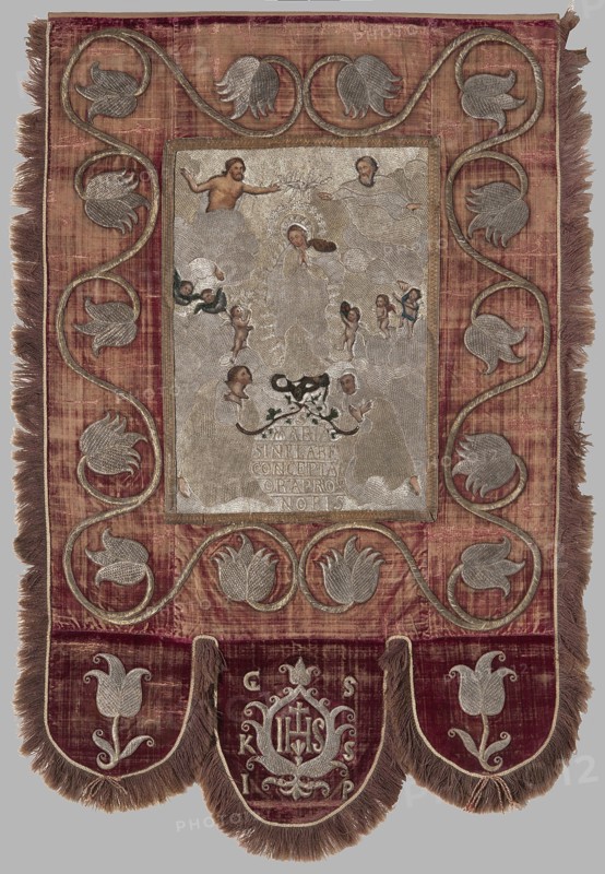 Church banner, Embroidered and painted textile, 17th century, Poland. Church banner with a scene showing Mary the Immaculate Conception Coronation of the Virgin Mary surrounded by God the Father, Christ, and the Dove of the Holy Spirit. Central image partly embroidered with gold thread on canvas and partly painted skin tones and flowers in oil on canvas; embroidery laid on a low backing; border of red silk velvet embroidered with floral tendrils. In the center Mary is surrounded by angels in rays; above right God the Father, above left Christ, above Mary's head the Dove. At the bottom two figures of monks in habits with folded hands, from which rose branches grow; between them the inscription “S/MARIA/SINIELABIE/CONCEPTA/ORAPRO/NOBIS.” Lower edge serrated in a semicircle: central larger “tooth” with a stylized palmette containing the letters IHS and around it the letters “GS/ KS/ IP”; smaller side teeth with stylized tulip branches. Materials: textiles, embroidered textiles. Dimensions...