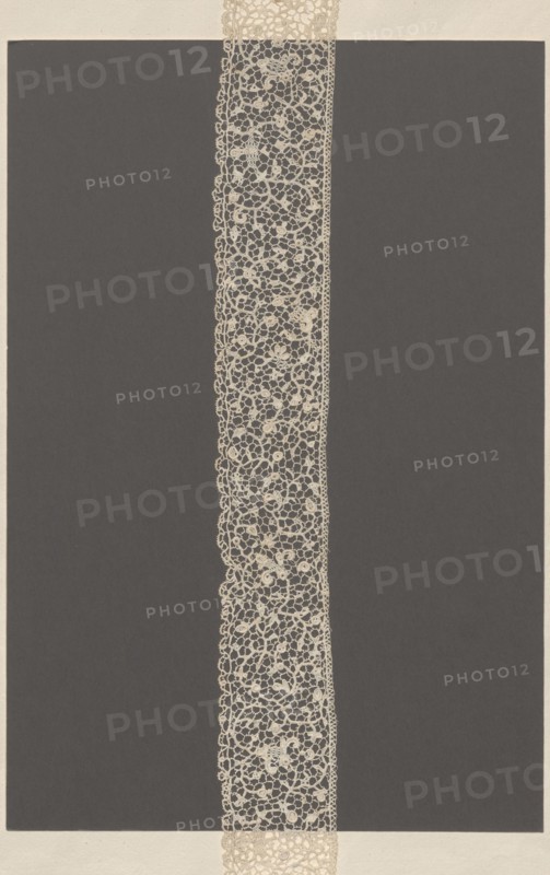 Lace fragment, needle lace, Krzeszowice Lesser Poland Voivodeship; fashion/clothing/women's/tailoring accessory. Pattern of flower branches forming a tendril. Joining de brides with picots. Lower edge with fine serrations, upper straight with braid. 17th–18th century, Venice; lace; length 61 cm, width 5 cm., A narrow vertical strip of intricate lace runs down the center of the image against a large dark rectangular background, with the lace appearing in a light beige color and the background in a deep charcoal or dark gray; the lace shows a delicate openwork pattern of looping floral and circular motifs and a slightly scalloped outer edge, and a pale off-white border frames the entire composition at the top and bottom.