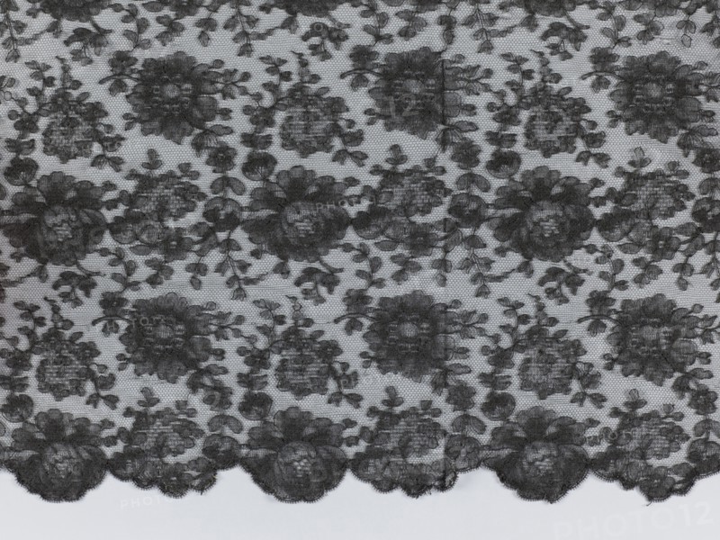 Shawl, shawls, floral ornaments, clothing accessories, women's clothing, fashion, Pattern on a mesh background, reported. Long edges: upper - sewn-on narrow stripe made using the bobbin technique, lower serrated, without distinctive edge ornament. Short sides of the shawl cut off and left unfinished. 1st half of the 19th century, France, fabrics, length 245 cm, width 100 cm, A patterned piece of fabric with a repeating floral lace design spread flat, showing a sheer background with darker floral motifs and leafy vines; the lace edge along the bottom has a scalloped outline with larger flower shapes, while the interior features a dense arrangement of roses and smaller blossoms connected by thin stems. The visible colors are black and light gray.