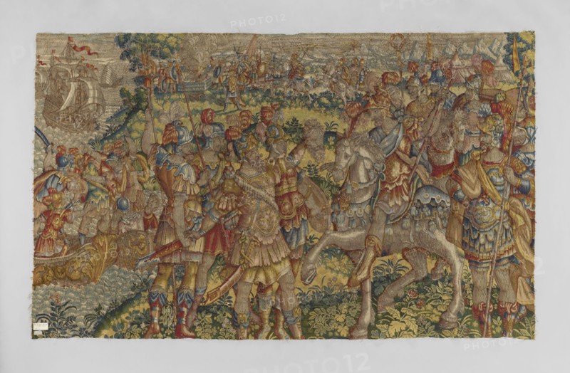Figural tapestry by Franz Geubels 1535–1590, 2nd half of the 16th century, Brussels. Tapestry depicting a horizontal battle scene: in the foreground center a victorious general Caesar on horseback; a soldier in front holds the severed head of Pompey, flanked by other soldiers; on the right foreground a leader on horseback with a soldier holding a severed head. Background right shows a seascape with ships filled with troops; middle and left background show tents, troops on horseback, and a bonfire on the seashore; high horizon with outline of mountains. No border border clipped. Limited, saturated palette dominated by green, red, and sapphire; additional colors sand and yellow. Materials: woven decorative fabric; height 212 cm, width 347 cm., The image shows a richly colored woven tapestry depicting a crowded outdoor scene with a group of figures in elaborate clothing and armor, several horses, and a background with tents and a distant shoreline with ships; visible colors include gold, ...