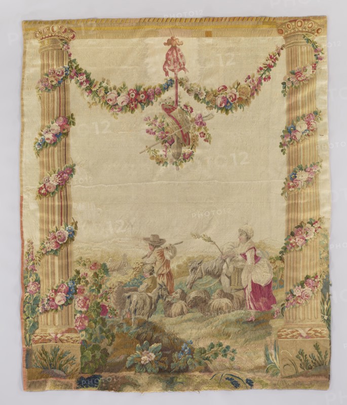 Figural tapestry: Pastoral scene with a shepherd, a shepherdess, and a boy. In the center, a man with a knot on a stick, accompanied by a boy and a woman with a switch, head right toward a distant village. In the foreground a goat and a flock of sheep, a donkey emerging from behind the woman. Scene flanked by tall columns decorated with garlands of interwoven flowers; above, between the columns, a garland supports the architrave. Smaller flower garlands hang from a pendant entwining a shepherd's hat, staff, and wineskin. Colors: light cream background, multi-colored flower garlands predominating in pink and green whitish tones. Fabrics with similar pastoral love scenes were popular from the late 1770s and were modeled on drawings by Jean-Baptiste Marie Huet 1745–1811. Dated ca. 1750–1780, France. Materials: textiles tapestry/weaving. Dimensions: height 220 cm, width 180 cm., A rectangular woven textile with a pale cream background framed by two tall fluted columns on the left and right...