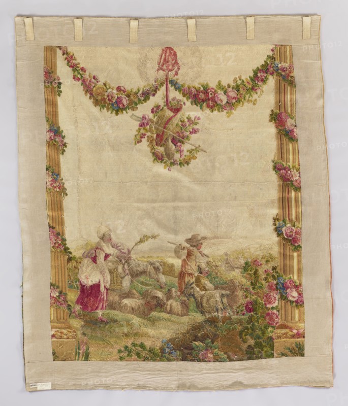Figural tapestry, Pastoral scene with a shepherd, a shepherdess, and a boy. In the center of the landscape, a man with a knot on a stick, accompanied by a boy and a woman with a switch in hand, are heading right toward a distant village. In front of them, closer to the foreground, stands a goat and a flock of sheep, while a donkey emerges from behind the woman. The scene is flanked by tall columns decorated with garlands of interwoven flowers. Above, between the columns, a similar garland hangs attached to the architrave; smaller flower garlands hang low on a pendant entwining a shepherd's hat, staff, and wineskin. Colors: light cream background, multicolored flower garlands predominate in shades of pink and green in whitened tones. Fabrics with pastoral love scenes were popular from the late 1770s and were modeled on drawings by Jean-Baptiste Marie Huet 1745–1811. Date: 1750–1780. Place of origin: France. Material: fabric tapestry. Dimensions: height 220 cm, width 180 cm., A rectangul...
