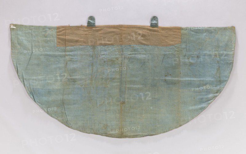 Church cope of silver brocade with Chinese motifs. Pretext sewn from two Polish fabrics: cream satin with a floral pattern and sky-blue satin with blue stripes, trimmed with galloon. Hood trimmed with fringe; silver buckle with a carp-scale motif. Skirt of silk lampas, woven with a blue silk weft and embellished with metal thread and silk yarn; background satin warp shows liseré decoration forming the overlay. Motifs symmetrically composed of large fanciful vases with Chinese figures topped by Chinese-style buildings forming a chalice; between these are birds and elements of Chinese architecture in a chinoiserie style. Metal brocade thread on a loosely braided, crimped white silk core; broidering threads: braided metal thread and orange, blue, white, yellow silk yarn. Measurements: height 51 × width approx. 77 cm report; skirt fabric/vestment length 128 × width 254 cm entry. France, early 18th century silk fabric for the skirt; overall 18th century liturgical vestment., A large semicir...