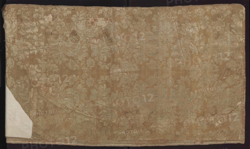 Fabric fragment, fragments of silk patterned fabric, pseudo-damask with floral and plant patterns, stripes; fragment sewn from two salmon-white damask-type fabrics promoted stripes, differing slightly in pattern and ply width. Damask effect achieved by different colors of warps and wefts; pattern in mirror symmetry. Tiny blossoms spill out from large, blooming peony-type flowers. White taffeta background, salmon pattern — gros de Tours. Panel 1 report: height 29 x width 49.5 cm; edge width 0.5 cm. Panel 2: damask effect achieved by different colours of warps and wefts; pattern in mirror symmetry; large fruit and blooming flowers with lace motifs resembling combs of French needlepoint lace. White taffeta background, salmon pattern — gros de Tours. Panel 2 report: height 38.5 x width 50.5 cm; edge width 0.4 cm. Date: 1735–1745. Place of origin: France. Overall fabric dimensions: height 98 cm, width 97 cm., A large rectangular piece of fabric with a repeating floral damask pattern, showin...