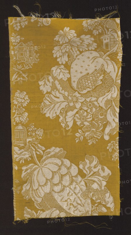 Fabric fragment, fabrics, 18th-century silk fabrics, fragments of silk fabrics, patterned fabrics, chinoiserie, plant patterns, patterns with architectural motifs, fabrics with preserved selvedge. A type of two-tone damask in yellow and white. Background: gros de Tours yellow main warp, yellow binding warp; pattern: plain weave white leading wefts, white binding warp. Design: motifs of flowers and large stylized fruit between which are placed fragments of miniature architecture; chinoiserie-type pattern composition. The fruit resembles quinces in shape. Background - yellow, pattern - white. Border width: 0.4 cm. The fabric pattern is characteristic of the period of the 18th century, 1730–1740, France. Height: 40.5 cm, width: 21 cm., A rectangular textile fragment with a mustard yellow background features an ornate off-white floral and fruit pattern showing large stylized blossoms, leaves, and a segmented fruit, with smaller blossoms and foliage filling spaces; a few architectural motif...