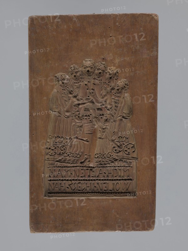 Double-sided gingerbread mould. Obverse: group of figures—two women and a child; rectangular form; one side shows three figures in 17th–18th century costumes: two women in long patterned dresses with low necklines and wigs, a child probably a boy in a long shirt, culottes and stockings holding a toy; both women hold baskets and one holds a hare; a small dog at the bottom next to a basket; beneath an inscription in German: LIEBES KIND DENCK DOCH / NECHEN WELCHEN KAM GERG, NOCH. Reverse: scene of a man surrounded by five women and two girls, all in 17th–18th century costumes; the man wearing a justaucorps, culottes and stockings, the women and girls in long patterned dresses with low necklines; German inscription at the bottom: MICH ALTEN MAN / WOLEN IHRER HAHN. Material: gingerbread mould for gingerbread; decorative art, figurative genre scenes, moral satire, plant ornaments;, 19th century; Province of Silesia 1742–1918. Dimensions: height 28 cm, width 17.3 cm, depth 4 cm., A rectangula...