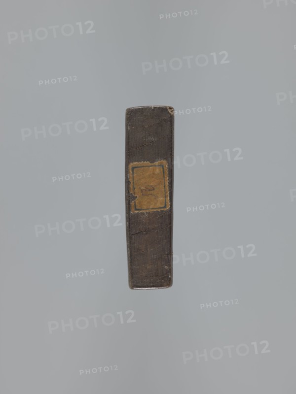 Double-sided gingerbread mould. Obverse: rectangular floral and geometric ornament — a rectangular decorative motif containing a rosette and stylised plants. Reverse: image of the Archangel Michael in a long patterned robe decorated with a plant-twig motif, holding scales in his right hand and a sword in his left; at the figure’s feet a geometric-plant ornament. Date engraved on the edge: 1806 with the letter S against an anchor mark of the woodcarver or gingerbread maker—owner of the mould. Unknown creator woodcarver or gingerbread maker; gingerbread mould; gingerbread; decorative folk art; angels iconography; figurative scenes; Archangel Michael iconography; Christianity; folk-style decorations; religious motifs; floral ornaments; Silesia Province of Silesia, 1742–1918. Double-sided, rectangular mould; form: bas-relief; dimensions: height 11.6 cm, width 30.5 cm, depth 3 cm., A single narrow rectangular object is centered against a pale gray background; the object appears dark brown w...