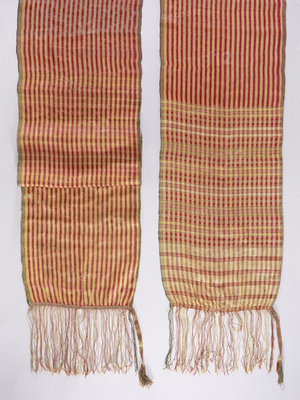 Belt, 19th century, Russia . Geometric ornaments; reversible kontusz belt for Polish men's costume. The belt ends: one 111 cm long, the other 69–70 cm long, are checkered with stripes in red, gold, straw, and light olive. The middle of the belt has longitudinal stripes in red and gold. A long silk fringe is sewn on, decorated with a sewn-on selvedge at the point of attachment. Clothing accessory; length 412 cm, width 41.5 cm., A pair of long woven textile panels with vertical stripe patterns and fringed ends, shown side by side against a pale background; the fabric displays alternating red and yellow stripes that form a denser checked area on one panel, with the woven threads creating subtle variations in tone; the lower edges end in tangled fringe in mixed colors including red, yellow, and green, and each panel has a narrow selvage with darker edging.