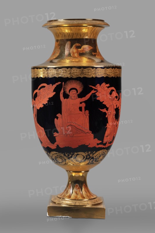 Amphora vase with a retinue of Greek gods; early 19th century, Berlin, Germany. Ovoid body with a separated recess and slightly upturned neck; on a spool foot and square plinth. Black ground with overglaze-painted red-figure retinue: Zeus on a throne surrounded by the Muses, Neptune Poseidon with Amphitrite, and Athena . Traces of gilded and engraved antique-looking floral ornament under the neck, on the lower body, and on the neck under the rim. Around the gilded neck and foot, painted in sepia and brick brown, are five compositions featuring an eagle, insignia of power, a shield, a sword, a helmet, a dove, a floral wreath, and Neptune's attributes. A trail of leaves surrounds the foot. Foot mounted with a belly on a spindle., A tall ornamental vase with a flared rim and pedestal base, primarily showing deep black, bright gold, and vivid red-orange colors; the upper neck and rim area are gilded with gold and include decorative gold patterns and a painted gold bird; the main body is bl...