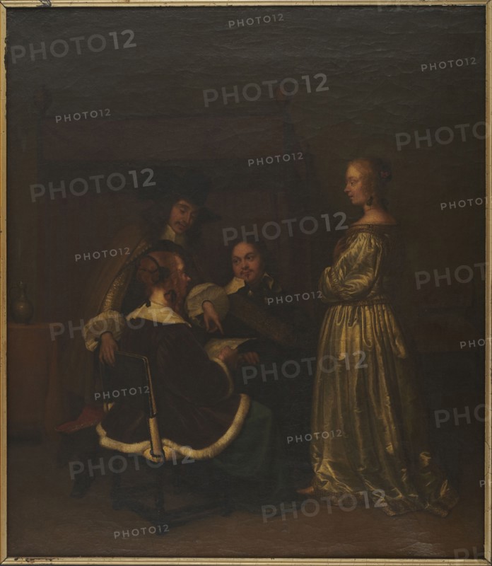 Reading a letter, Borch, Gerard ter, II 1617-1681 painter workshop, interiors, genre scenes, Dutch painting, genre painting, 17th century, painting, height 72 cm, width 64 cm, A dimly lit indoor scene shows a group of people gathered near a tall piece of furniture in the background. A standing woman on the right wears a long shiny gown in golden and cream tones and has her hair styled with a small decorative element; her hands are clasped near her chest. Three men sit and stand to the left, wearing dark clothing with white collars and cuffs and one with a dark wide-brimmed hat; one seated man has a dark cloak trimmed with white fur and sits on a dark wooden chair, another man leans forward pointing at an object being held, and a third man looks on with a contemplative expression. The room includes a small table with a pale vessel and warm brown and ochre tones in the background, and the overall palette features deep browns, dark greens, black, cream, gold, and muted reddish accents.
