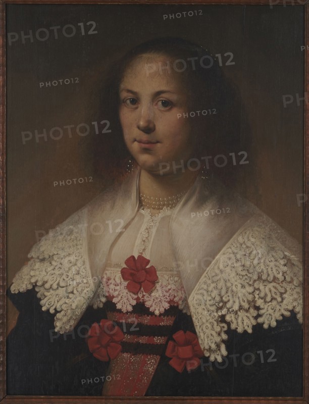 Portrait of a woman, unknown Dutch painter; female portrait, Dutch painting; pearls; bust portrait; 2nd half of the 17th century; painting; height 60.5 cm, width 46.5 cm; restitution provenance; Priority 2 - visual documentation; painter classification, A portrait of a woman shown from the chest up against a dark brown background; she has a pale complexion, dark curly hair framing her face, and brown eyes with a neutral expression. She wears a white lace collar with intricate patterns over a dark garment, and a sheer white shawl over her shoulders. There are several red fabric bows or flowers on the front of her clothing and a strand of pearls at her neckline. The visible colors include brown, dark brown, black, white, pale skin tones, and red.