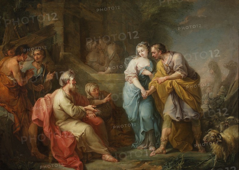 Jacob and Rachel before Laban, French painter fl. 18th century; author: Amigoni, Jacopo Italian painter; 1682–1752. Subject: Jacob the patriarch Bible, Laban Bible, Rachel Bible, Leah Bible. Medium: painting. Date: after the mid-18th century. Dimensions: painting height 104 cm, width 147 cm; with frame height 135 cm, width 174.5 cm, thickness 14 cm., A group of people gathered in an outdoor setting near a stone building, featuring a central young woman in pale blue and white drapery being held by a man wearing earthy yellow and brown garments; nearby an older seated man in light beige robes with a pink cloak draped around him faces them while another older figure beside him gestures; to the left a few standing figures in muted browns and ochres converse and point, while in the background a few shadowed figures stand in an archway; to the right a group of sheep with woolly beige and cream coats stands near the standing man, and low greenery and stone surfaces occupy the foreground; visi...