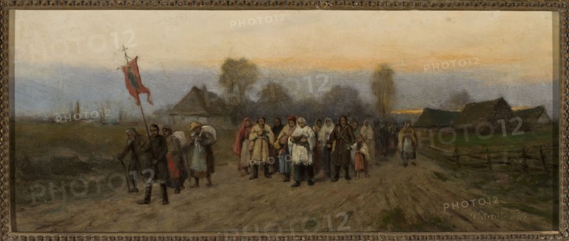 Village Procession - Pilgrimage, Streitt, Franciszek 1839–1890 painter, processions, pilgrimages, pilgrims, roads, village, landscapes, genre scenes, feretories, genre painting, priests, 1873, painting, height 17.5 cm, width 40 cm, A group of people walking along a dirt road in a rural landscape, wearing a variety of clothing including coats, shawls, and head coverings in colors such as brown, gray, white, red, blue, and beige; one person near the front carries a tall pole with a red flag, and others appear to carry bundles or wear cloaks. The scene shows a few simple buildings and fences set against a flat field and distant tree line, with a sky that transitions from pale gray to soft orange near the horizon. The overall palette includes muted earth tones of brown and green, with touches of red, blue, white, and gray.