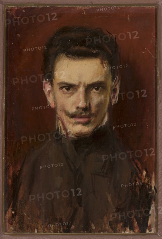 Self-portrait, Ignacy Marek 1874–1921; painter; portrait, modernism; male full-face self-portrait of a young artist; oil painting, height 60 cm, width 41 cm; end of the 19th century., A painted portrait of a man shown from the chest up against a deep reddish-brown background, featuring a pale skin tone with warm beige and pink highlights, dark hair, a narrow dark mustache, and dark eyes with a focused gaze; he wears a dark, loosely rendered garment in shades of brown and black, and the brushwork includes visible strokes and smudges in black, brown, red, and beige, with subtle hints of pink on the ears and lips.