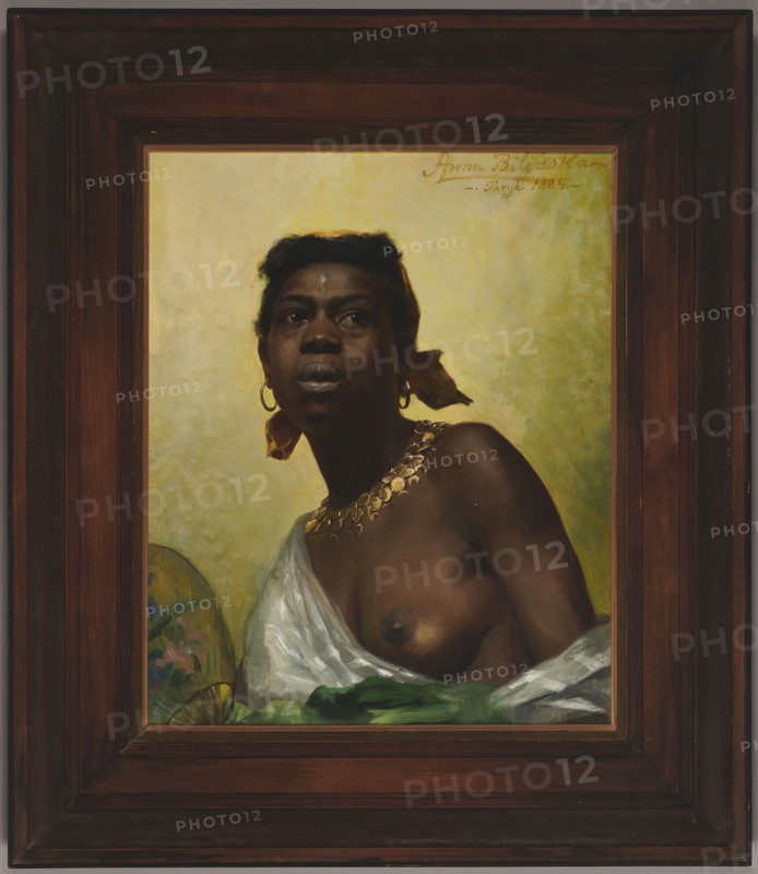 Black woman; Anna Bilinska-Bohdanowiczowa 1854–1893, painter; 1884, Paris; oil painting; academism; Académie Julian Paris; subject: female semi-nude portrait, three-quarter view, wearing earrings, fan, necklaces; themes: women's emancipation, slavery; Polish painting; height 63 cm, width 48.5 cm; masterpiece., A framed portrait of a dark-skinned woman shown from the chest up against a pale yellow-green background, wearing a white draped cloth and a green cloth at the bottom edge, with a gold necklace and hoop earrings, a yellow headscarf tied at the back with ends visible, short dark hair, and a neutral to serious facial expression; the frame is dark brown wood with layered molding and the painting includes warm brown, yellow, green, white, gold, and dark skin tones.