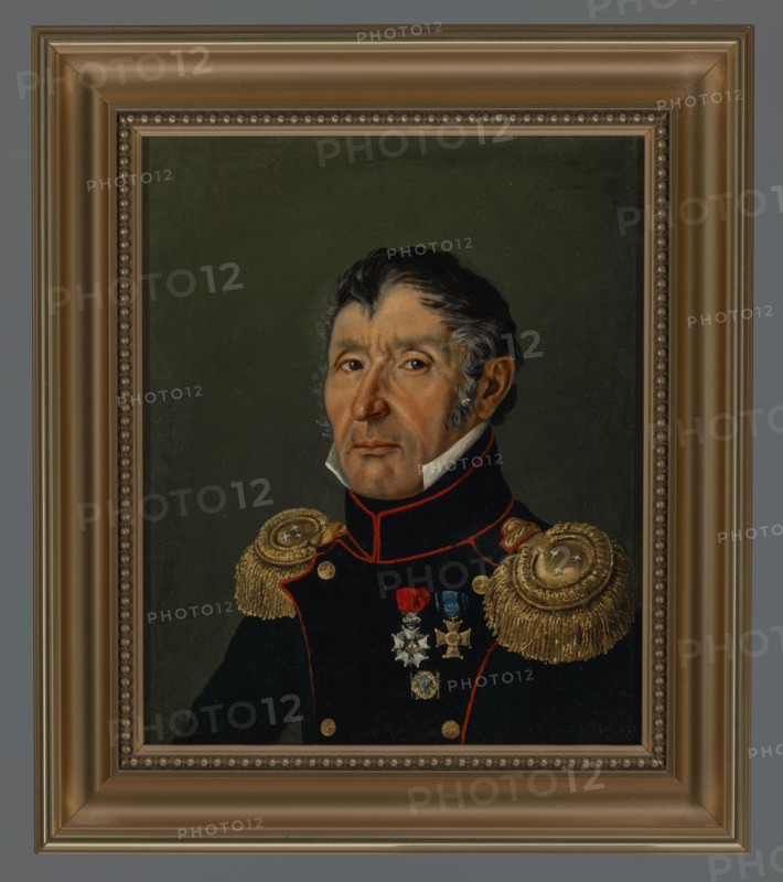 Portrait of Krzysztof Koryzna, lieutenant colonel of artillery from 1831, unknown Polish painter, ca. 1831, painting, height 26 cm, width 21.5 cm, A framed oil portrait of a man shown from the chest up wearing a dark military-style coat with red trim and gold epaulettes; his face has a neutral expression with visible skin tones and dark hair with gray sideburns, and he wears a high white collar. The background is a muted dark green. The coat features a group of metallic-looking medals and decorations in colors including gold, silver, red, and blue. The frame around the painting is a warm brownish-gold with ornamental beading and a wider outer molding in similar tones. Colors visible include dark green, black, red, gold, brown, white, gray, blue, silver, and skin tones.