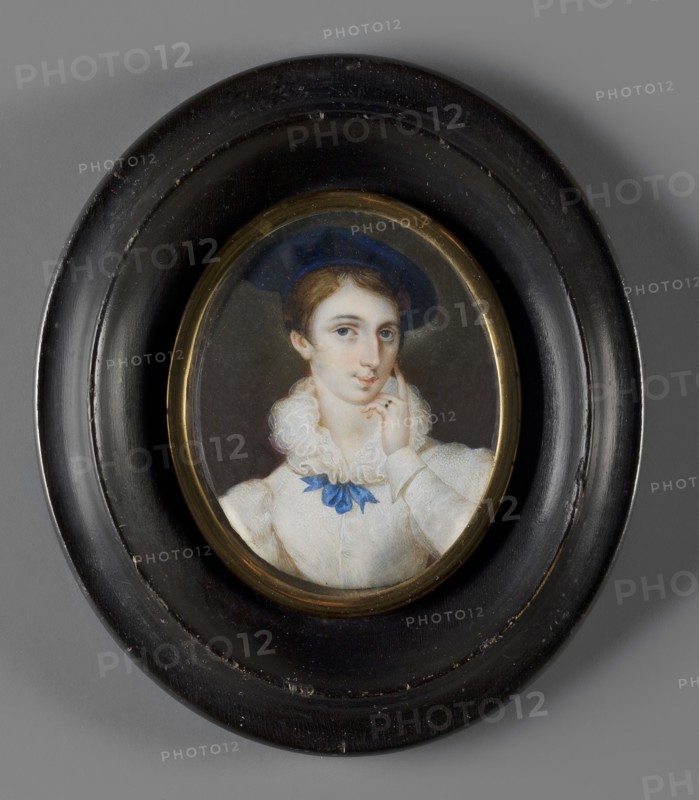 Portrait of Countess Melania Sobanska 1813–1887 née Uruska, painted by Józef Haar 1795–1838. Bust slightly to the left, head three-quarters to the right. Blond, smooth hair parted in the middle; large sapphire velvet beret; white dress with a rich ruff tied in a bow with a sapphire ribbon, large puffed sleeves; left arm bent at the elbow supports her cheek. Background: dark brown at the bottom, olive at the top. Binding: smooth oval rim of gilded bronze in an oval wooden frame, recessed and profiled, polished black. Thin convex glass. On the reverse of the binding: Melania / Sobanska / née Uruska / painted by Haar and two labels with no. 1691. Miniature, Poland, 1820; height 6.5 cm, width 5.3 cm. Melania Sobanska, daughter of Lukasz and Józefa Uruska; from 1832 wife of Aleksander Sobanski 1794–1861, an officer of the Polish Army and emigrant from 1831., An oval framed portrait of a young person wearing a dark blue hat and a white ruffled blouse with a blue ribbon at the collar, set aga...