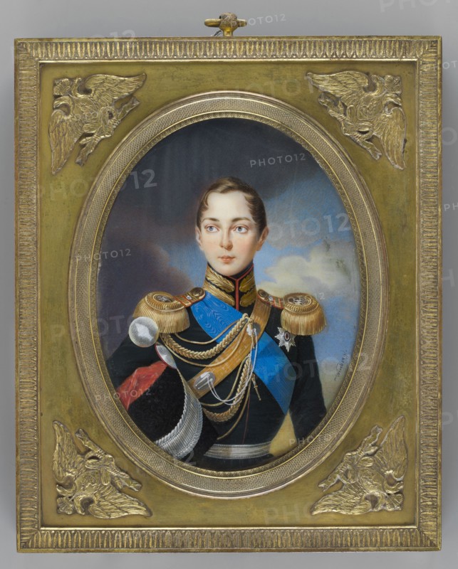 Alexander II Romanov 1808–1881, Tsar of Russia; painted by Ivan Winberg fl. 1800–1851. Miniature portrait height 17.2 cm, width 13.2 cm. Depicts boys, rulers, soldiers in uniforms and orders; male portrait with landscape and sky background. Dated 1834. Associated with Hessen and bei Rhein, Ernst Ludwig Grossherzog; 1868–1937 provenance/repossessions noted. Origin: Russia., A painted oval portrait set in an ornate rectangular gold frame shows a young person with fair skin and short brown hair wearing a dark military uniform with gold epaulettes, blue sash, and multiple gold cords and medals; the face has a neutral expression and light-colored eyes, and the background inside the oval shows cloudy sky tones in blue and gray. The surrounding frame is metallic gold with decorative raised corner motifs depicting stylized winged figures and a textured border, and visible colors include gold, blue, black, brown, red, white, gray, and muted flesh tones.