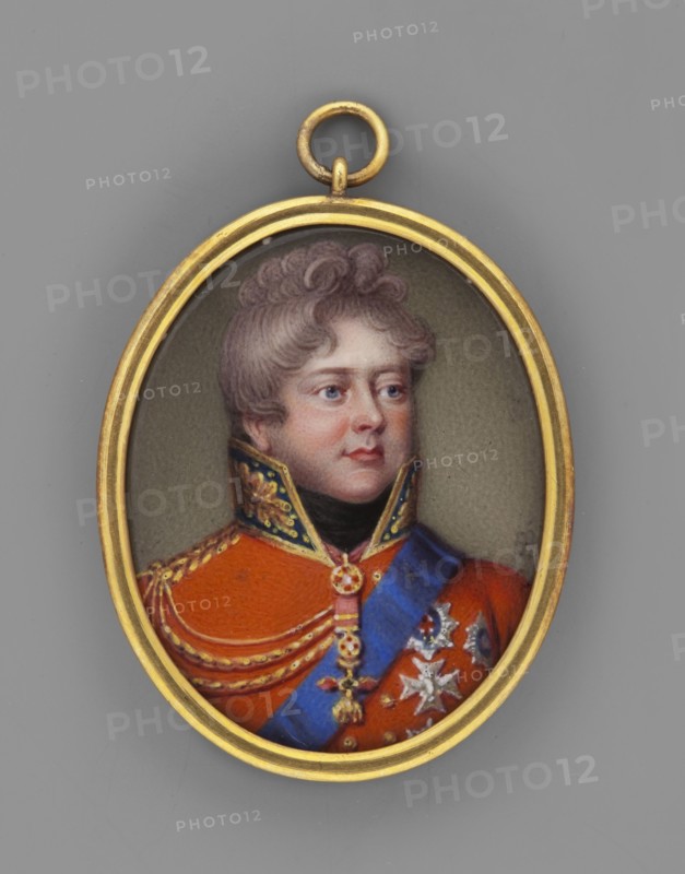 George IV of Hanover 1762–1830 in a British general's uniform. By Henry Bone 1755–1834. Probably a copy of an oil painting; miniature. Bust in full view, head to the right; thick grey/curled hair, dark eyes, black cravat, red uniform with gold braiding, epaulettes and insignia, numerous order stars, blue order sash, Order of the Golden Fleece around his neck. Olive-grey background. Narrow gilt/brass band binding. 1815, England. Height 3.7 cm, width 2.7 cm., An oval pendant with a gold rim contains a painted portrait of a person wearing an orange-red military-style coat with gold trim and decorative gold braiding, a blue sash across the chest, and star-shaped metallic decorations; the person has light skin, reddish cheeks, short curly light brown hair, and a neutral facial expression, set against a muted grayish-green background with the pendant ring visible at the top; visible colors include gold, orange-red, blue, light brown, pinkish skin tones, black, gray, silver, and muted green.
