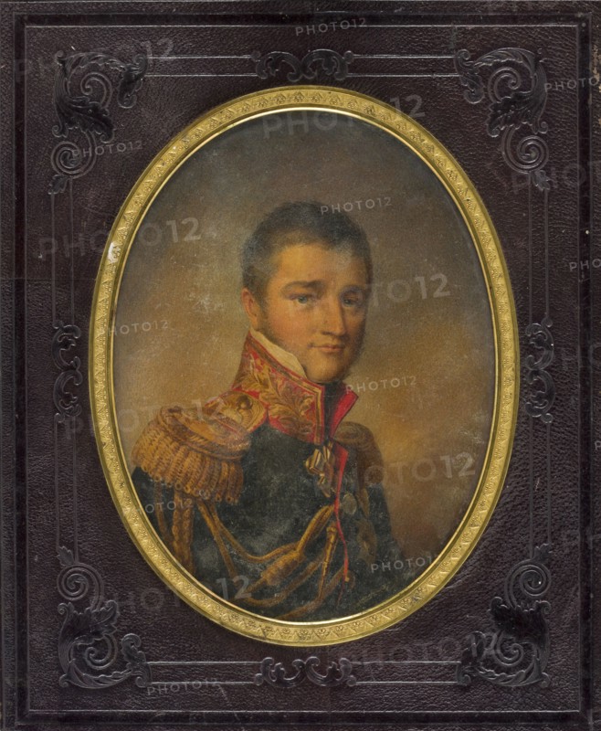 Michal Siemionowicz Vorontsov 1782–1856, Governor-General of New Russia, Tsar's governor in Bessarabia, husband of Elizabeth née Branicka; unknown artist; male portrait miniature height 15.7 cm, width 11.8 cm, 1820; depicts aristocratic military dress with uniforms and numerous orders: Order of St. Andrew the Apostle of the First Calling, Order of St. Vladimir, Order of the Red Eagle, Order of St. Anne, Order of St. George, Order of St. Stephen, Order of the Black Eagle Prussia, Order of the Bath, Order of the Seraphim, Order of St. Louis., An oval portrait of a man set within an ornate frame shows a person with short dark hair and a neutral expression, wearing a dark military-style coat with gold braided epaulettes and decorative gold and red trim; the background inside the oval is a muted brownish tone. The outer area around the oval is a textured dark surface with embossed scrollwork decorations in darker shades, and a gold inner rim encircles the oval. Visible colors include dark b...